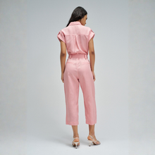 Load image into Gallery viewer, Woman wearing a pink jumpsuit on a gray background
