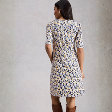 Load image into Gallery viewer, Woman wearing a floral dress with a neutral background
