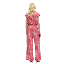 Load image into Gallery viewer, Woman wearing a red and white patterned jumpsuit on a white background
