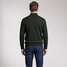 Load image into Gallery viewer, A man viewed from the back wearing a dark forest green mock-neck knit sweater and blue jeans, standing against a plain light gray studio background.
