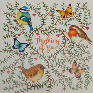 Detail of card with foliage and birds and butterflies - Thinking of You in the heart of the face of the card