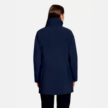 Load image into Gallery viewer, A woman viewed from the back wearing a dark navy blue mid-length coat with a high collar and long sleeves, paired with black pants, against a light gray studio background.
