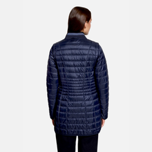 Load image into Gallery viewer, A woman viewed from the back wearing a dark navy quilted puffer jacket and dark pants against a light gray studio background.
