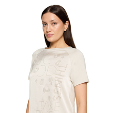 Load image into Gallery viewer, A woman wearing a cream-colored short-sleeve t-shirt with rhinestone text spelling 'GOOD SMILE TAKE TIME' on the front, photographed against a solid white background.

