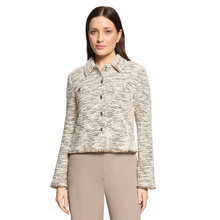Load image into Gallery viewer, A woman modeling a cropped, long-sleeve tweed jacket in a beige and black marled pattern, paired with beige trousers, against a plain white background.
