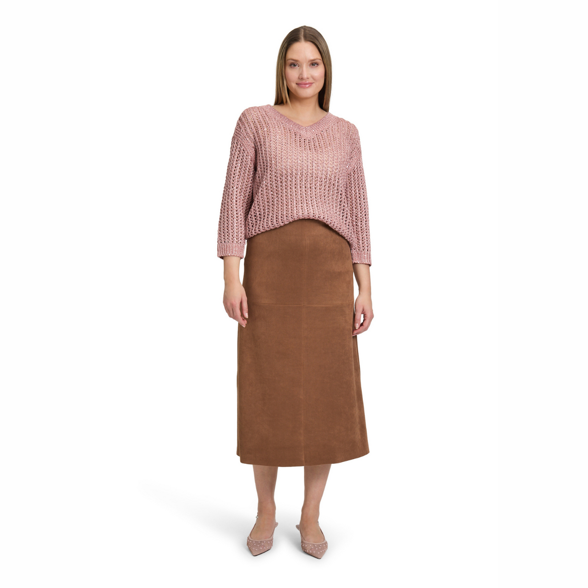 Woman wearing a pink sweater and brown skirt on a white background