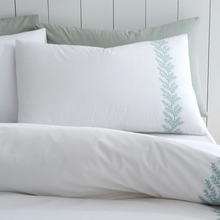 Load image into Gallery viewer, White bedding set with green embroidery on a light gray background
