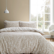 Load image into Gallery viewer, Neatly made bed with floral patterned bedding in a bright bedroom.
