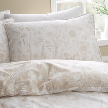 Load image into Gallery viewer, Floral patterned bedding set on a bed with a window in the background
