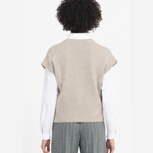 Load image into Gallery viewer, Back view of a person wearing a beige sleeveless knit sweater vest over a white collared shirt and gray pinstriped trousers, against a plain light background.
