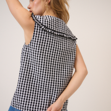 Load image into Gallery viewer, Black and white checkered sleeveless top worn by a person on a plain background
