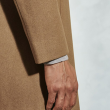 Load image into Gallery viewer, Close-up of a person wearing a beige coat with a white background
