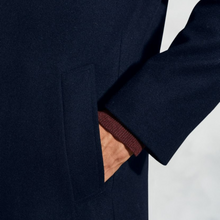Load image into Gallery viewer, Close-up of a navy blue coat with a brown lining on a white background
