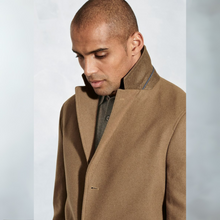 Load image into Gallery viewer, Man wearing a brown coat against a light gray background
