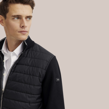 Load image into Gallery viewer, Close side view of Model wearing Bugatti hybrid full zip, In Black.
