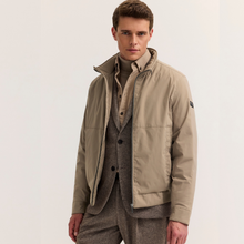 Load image into Gallery viewer, Model in beige jacket over suit on white background 
