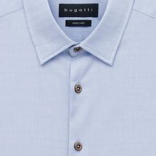Load image into Gallery viewer, Close-up of a light blue piqué button-down shirt collar with brown buttons and a black Bugatti neck label.
