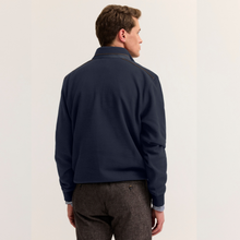 Load image into Gallery viewer, A man shown from the back wearing a navy blue quarter-zip jacket with contrasting brown trim on the shoulders, paired with brown tweed trousers, against a plain off-white background.
