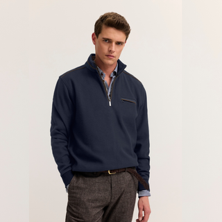 Model in Navy jumper with grey trouser on white background 