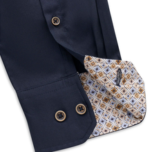 Load image into Gallery viewer, Close-up of a navy dress shirt sleeve showing a patterned inner cuff lining with geometric brown, beige, and white motifs, plus gold-tone buttons.
