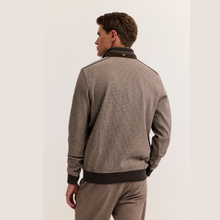 Load image into Gallery viewer, A man shown from the back wearing a textured taupe-gray zip-up jacket with dark brown ribbed trim and matching trousers, photographed against a clean off-white studio background.
