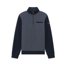 Load image into Gallery viewer, A men's quarter-zip pullover sweater with a heathered slate blue body and solid dark navy sleeves, collar, and hem, featuring a small brown Barbour logo patch on the left sleeve.
