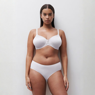 Woman wearing a white bikini against a plain background