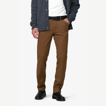 Load image into Gallery viewer, A man wearing slim-fit brown chinos, styled with a white t-shirt, dark gray cardigan, black belt, and black leather shoes, shown from the chest down on a light gray studio background.
