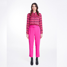 Load image into Gallery viewer, A model wearing the Badoo Hot Pink Belted Trouser in Hot Pink. 
