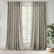 Load image into Gallery viewer, Textured curtains hanging in front of a window with a plant on a windowsill.
