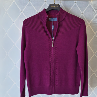 Plum cardigan on hanger with bright background 