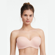 Load image into Gallery viewer, A close up of a model wearing the Chantelle Norah Strapless Convertible Bra in Natural. 
