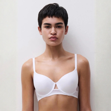 Load image into Gallery viewer, Model wearing a white bra against a plain background
