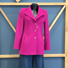 Load image into Gallery viewer, Pink coat on a mannequin against a blue wall with wooden geometric patterns
