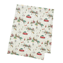 Load image into Gallery viewer, Tea towel with a festive design of cars, houses, and people on a white background
