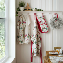 Load image into Gallery viewer, Kitchen wall with aprons, oven mitts, and a wreath on a white paneled wall.
