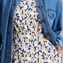 Load image into Gallery viewer, Person wearing a blue denim jacket over a patterned dress with butterfly design.
