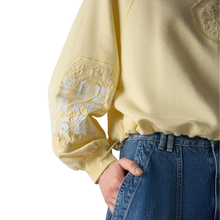 Load image into Gallery viewer, Yellow sweatshirt with lace details on sleeves and blue jeans against a white background
