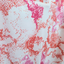 Load image into Gallery viewer, Close-up of fabric with pink and red abstract pattern on white background
