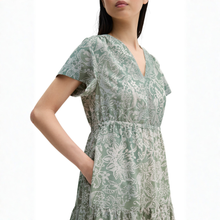 Load image into Gallery viewer, Woman wearing a green floral dress on a white background
