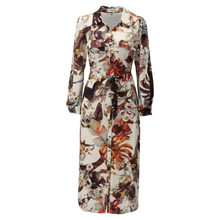 Load image into Gallery viewer, A long-sleeve midi shirt dress with a botanical and abstract floral print in earthy tones of brown, rust orange, and beige on a white background.
