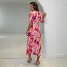 Load image into Gallery viewer, Woman wearing a pink floral dress in a minimal white room
