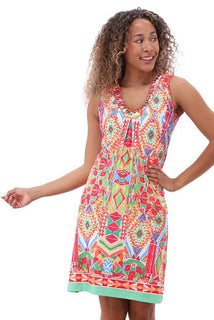 Woman wearing a colorful patterned dress on a white background