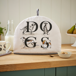 Tea cozy with dog illustrations and 'DOG' text on a kitchen counter.