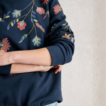 Load image into Gallery viewer, Navy blue sweatshirt with floral embroidery on a neutral background
