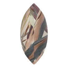 Load image into Gallery viewer, A single decorative throw pillow with a marquise-shaped silhouette, featuring an abstract brushstroke pattern in muted tones of brown, beige, gray, and burgundy on a plain white background.
