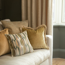 Load image into Gallery viewer, Decorative pillows on a sofa with a neutral color scheme.
