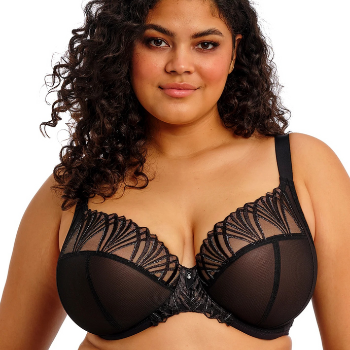 Woman wearing a black lace bra on a white background