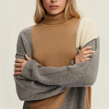 Load image into Gallery viewer, Woman wearing a brown turtleneck sweater with gray sleeves on a beige background
