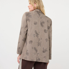 Load image into Gallery viewer, A woman shown from the back wearing a beige blazer with a brown paisley pattern and dark brown trousers, photographed against a plain light gray studio background.
